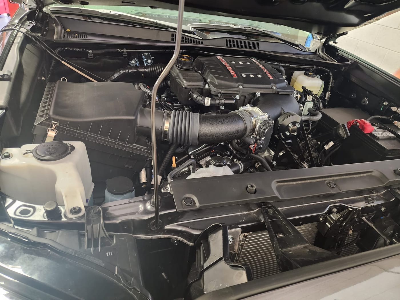 Magnuson supercharger and intake fitted in a Toyota Tacoma 3.5L engine bay by Tuned Yota